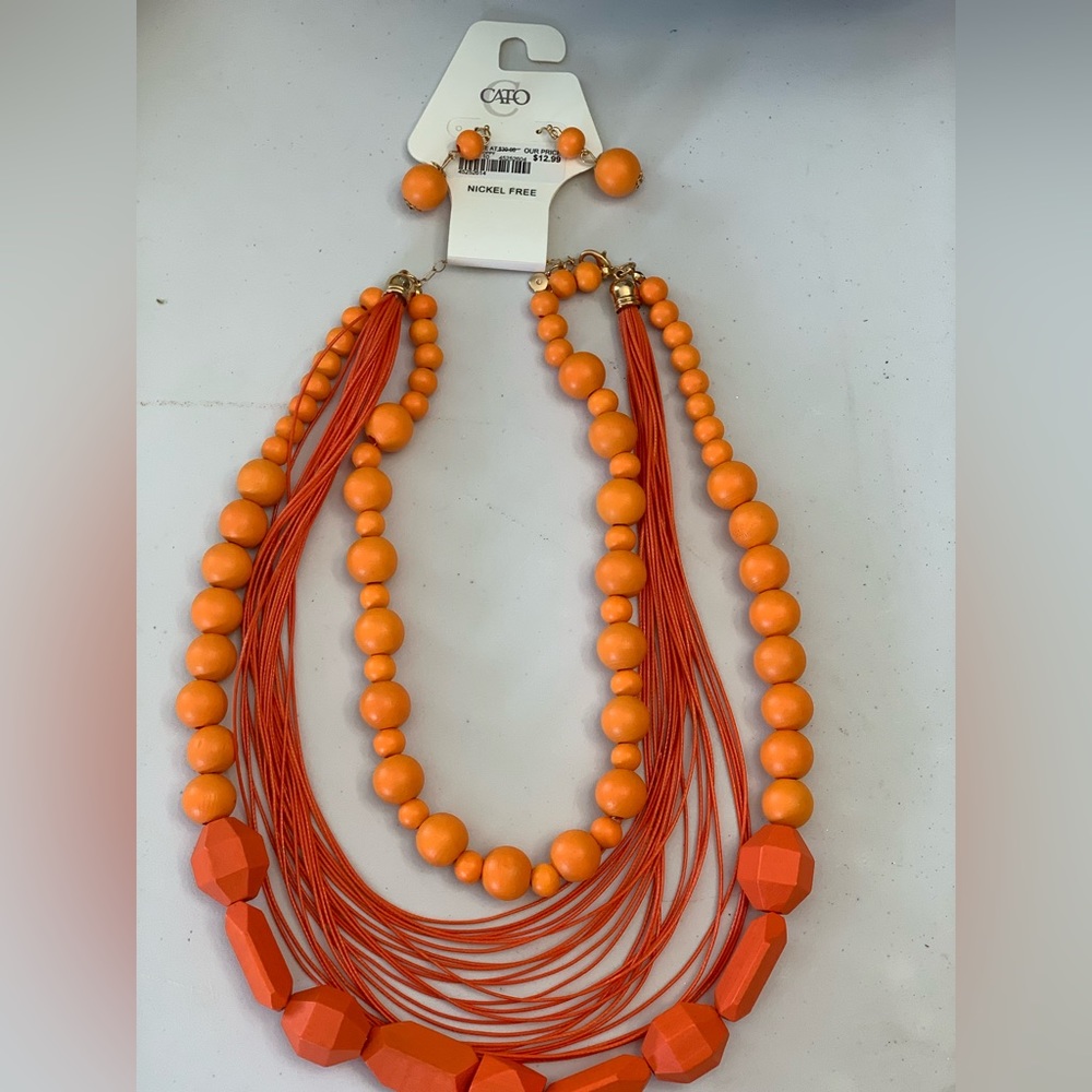 Fashion jewelry set.  Orange necklace with matching earrings.